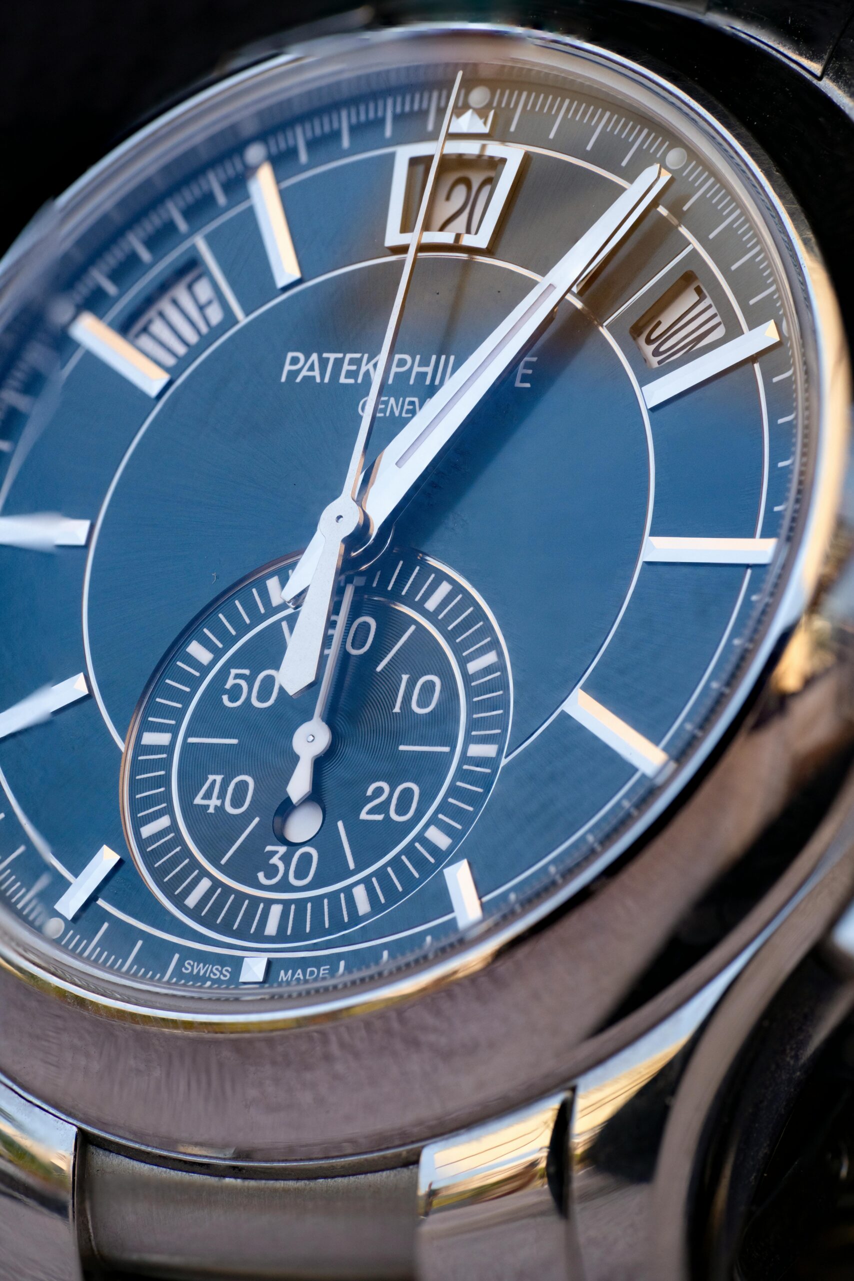 Detailed closeup of a luxury watch with a blue dial, capturing fine details and elegance.